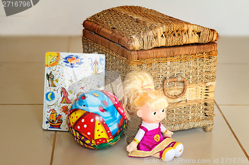 Image of Children's toys and the container for their storage.