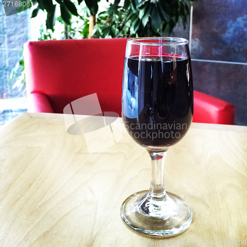 Image of Glass of red wine on the table