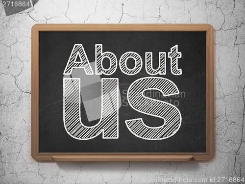 Image of Advertising concept: About Us on chalkboard background