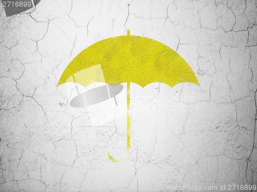 Image of Protection concept: Umbrella on wall background