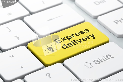 Image of Business concept: Energy Saving Lamp and Express Delivery on computer keyboard background