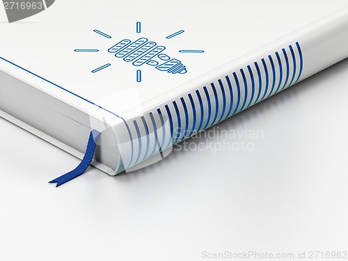 Image of Business concept: closed book, Energy Saving Lamp on white background