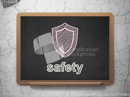 Image of Privacy concept: Shield and Safety on chalkboard background