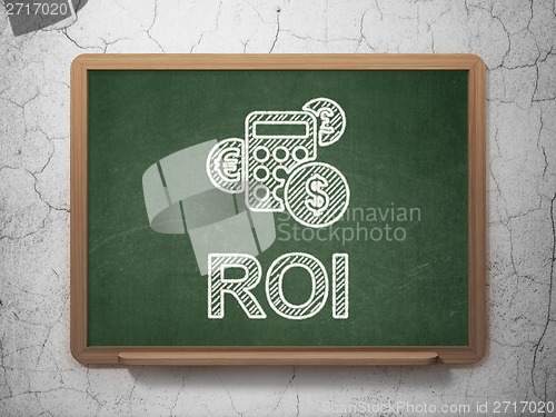 Image of Business concept: Calculator and ROI on chalkboard background