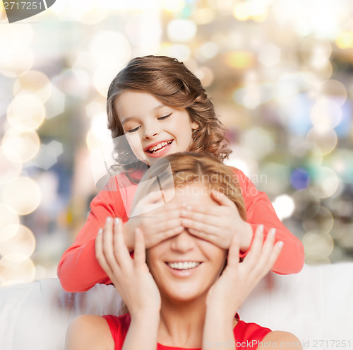 Image of smiling mother and daughter making a joke