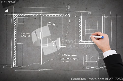 Image of close up of businessman drawing blueprint