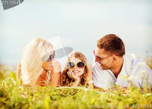 Image of happy family with blue sky and green grass