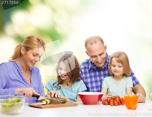 Image of happy family with two kids making dinner at home