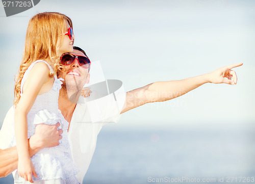 Image of happy father and child in sunglasses over blue sky