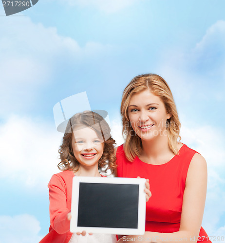 Image of smiling mother and daughter with tablet pc