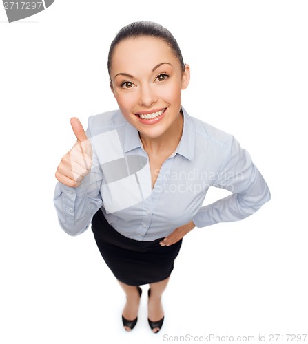 Image of smiling asian businesswoman showing thumbs up