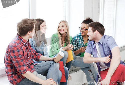 Image of students communicating and laughing at school