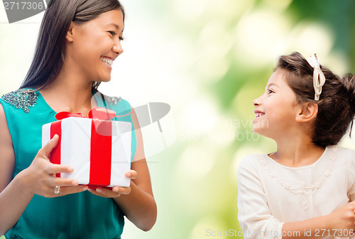 Image of happy mother and child girl with gift box