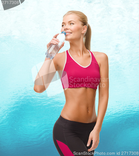 Image of smiling woman with bottle of water
