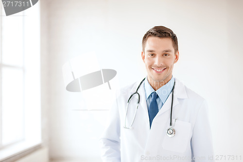 Image of young male doctor with stethoscope in hospital