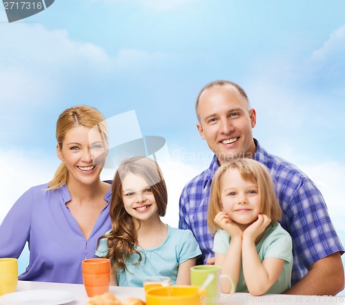 Image of happy family with two kids with having breakfast