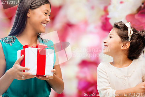 Image of happy mother and child girl with gift box