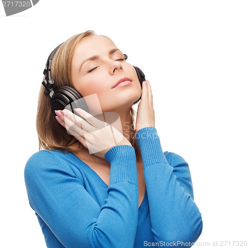 Image of calm young woman with headphones