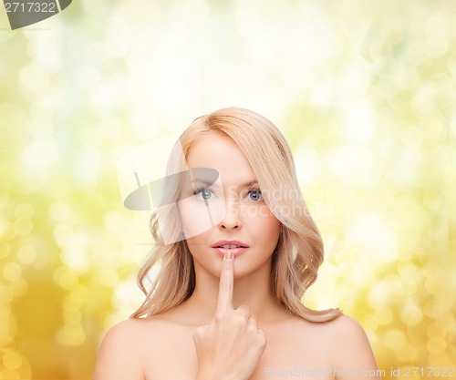 Image of woman touching her lips