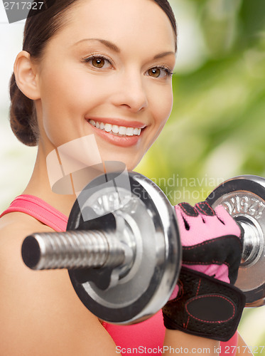 Image of asian sporty woman with heavy dumbbell