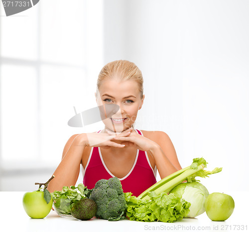 Image of smiling sporty woman with organic food