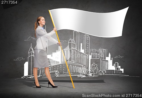 Image of smiling woman holding flagpole with white flag