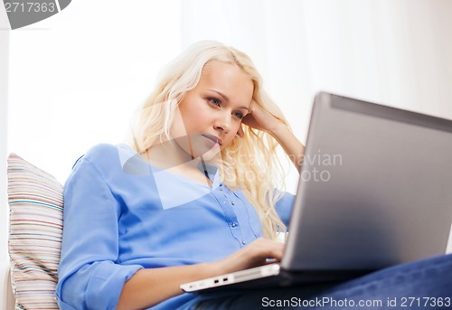 Image of woman with laptop computer at home