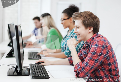 Image of student with computer studying at school