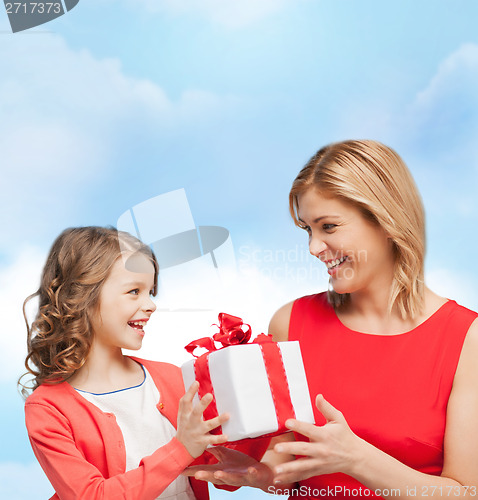 Image of smiling mother and daughter with gift box