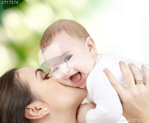 Image of laughing baby playing with mother