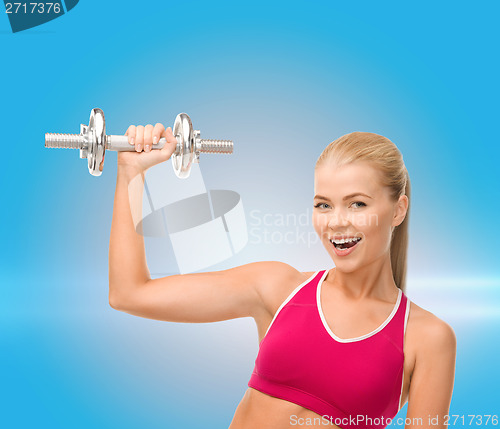 Image of smiling woman with heavy steel dumbbell