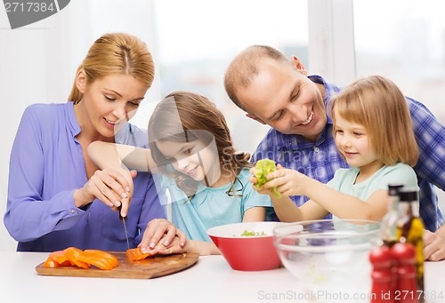 Image of happy family with two kids making dinner at home