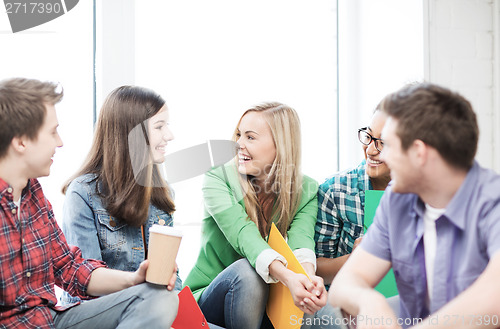 Image of students communicating and laughing at school