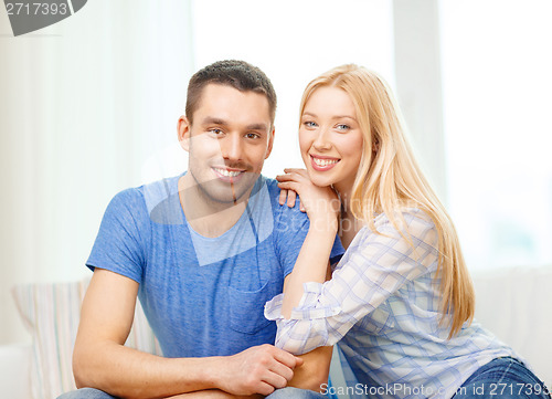 Image of smiling happy couple at home