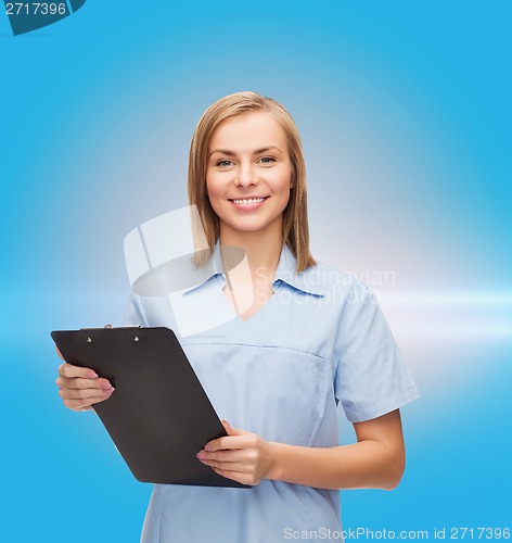 Image of smiling female doctor or nurse with clipboard