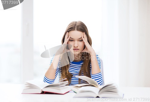 Image of stressed student girl with books