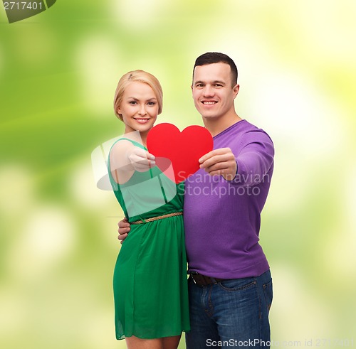 Image of smiling couple holding big red heart