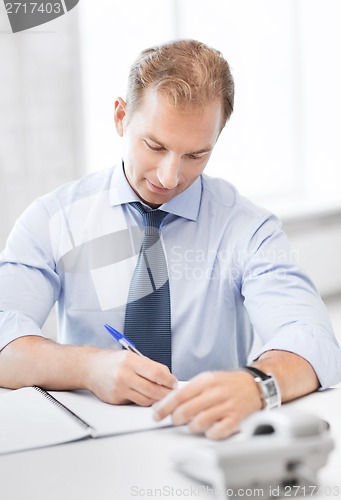 Image of handsome businessman working in the office