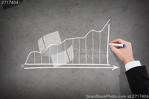 Image of close up of businessman drawing growing graph