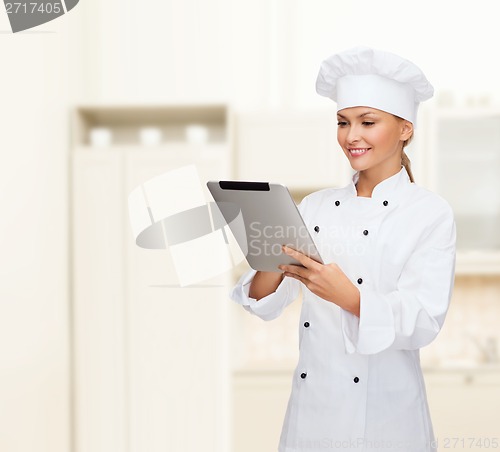 Image of smiling female chef with tablet pc computer