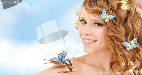 Image of happy teenage girl with butterflies in hair