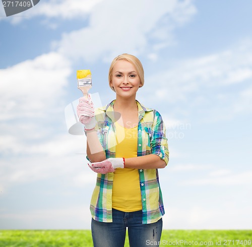 Image of smiling woman with paintbrush