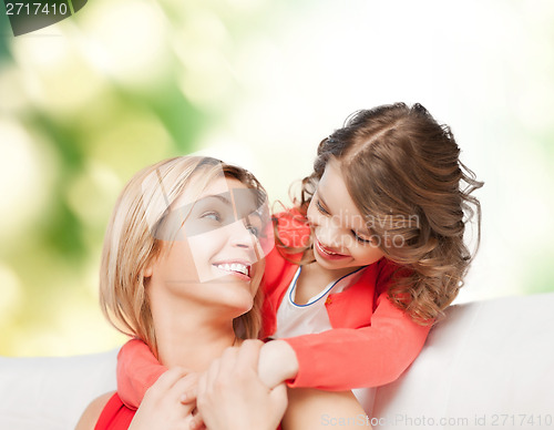 Image of smiling mother and daughter hugging