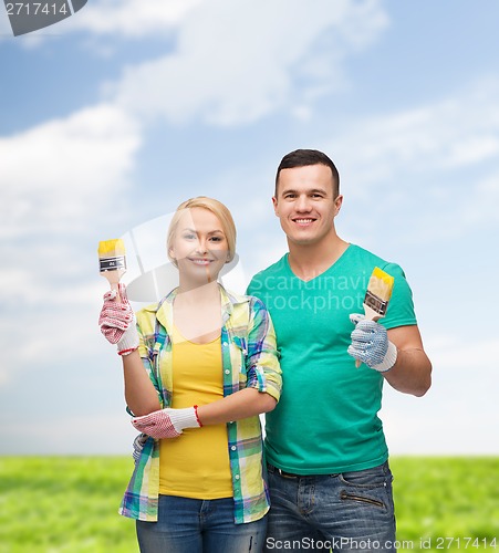 Image of smiling couple with paintbrush