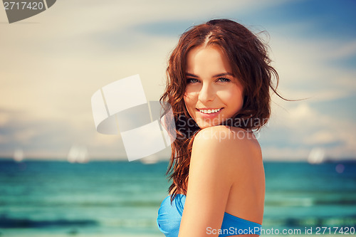 Image of happy smiling woman on the beach