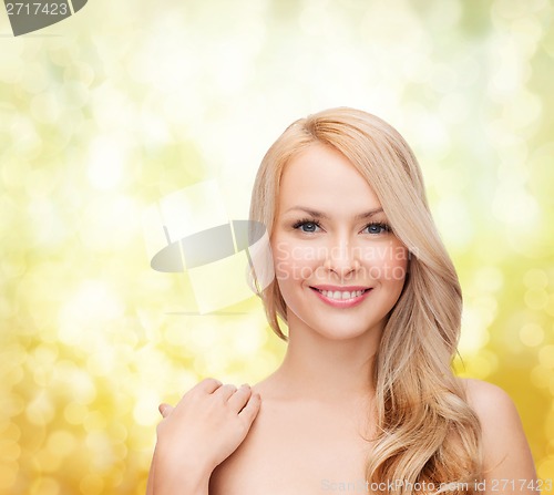 Image of face and shoulders of happy woman with long hair