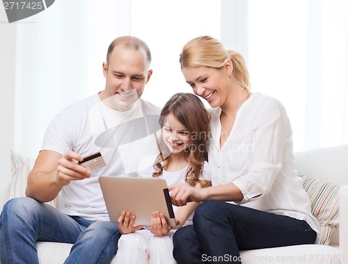 Image of parents and girl with tablet pc and credit card