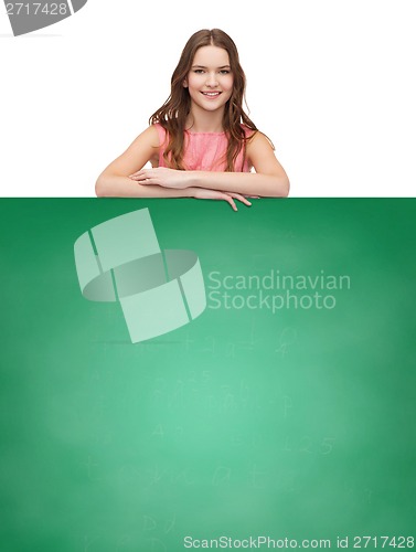 Image of young woman in dress with white blank board