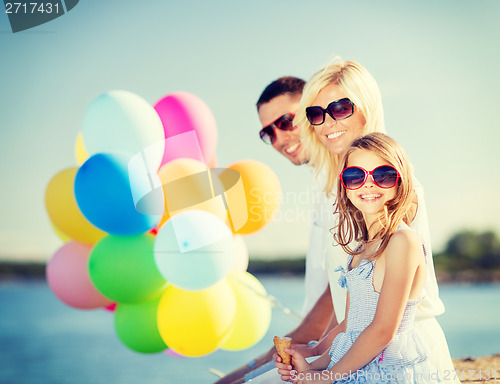 Image of family with colorful balloons