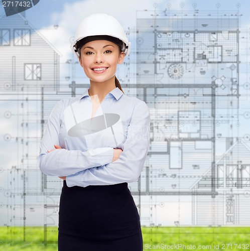 Image of friendly smiling businesswoman in white helmet